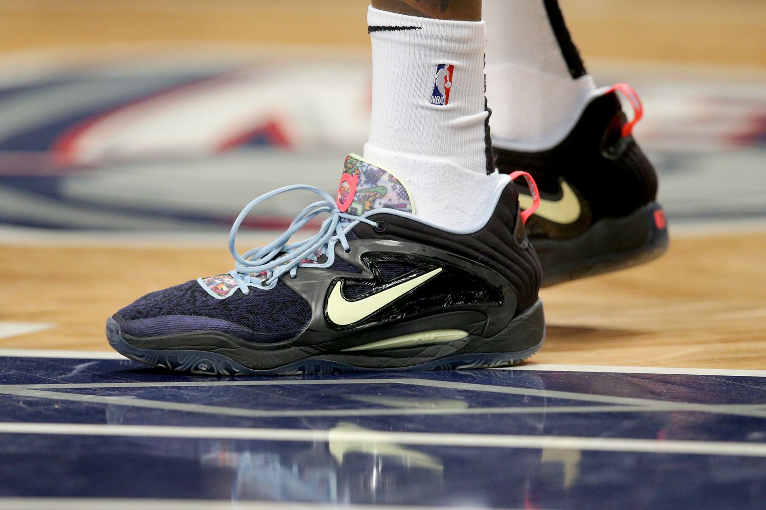 Black, yellow, and blue Nike KD shoes.